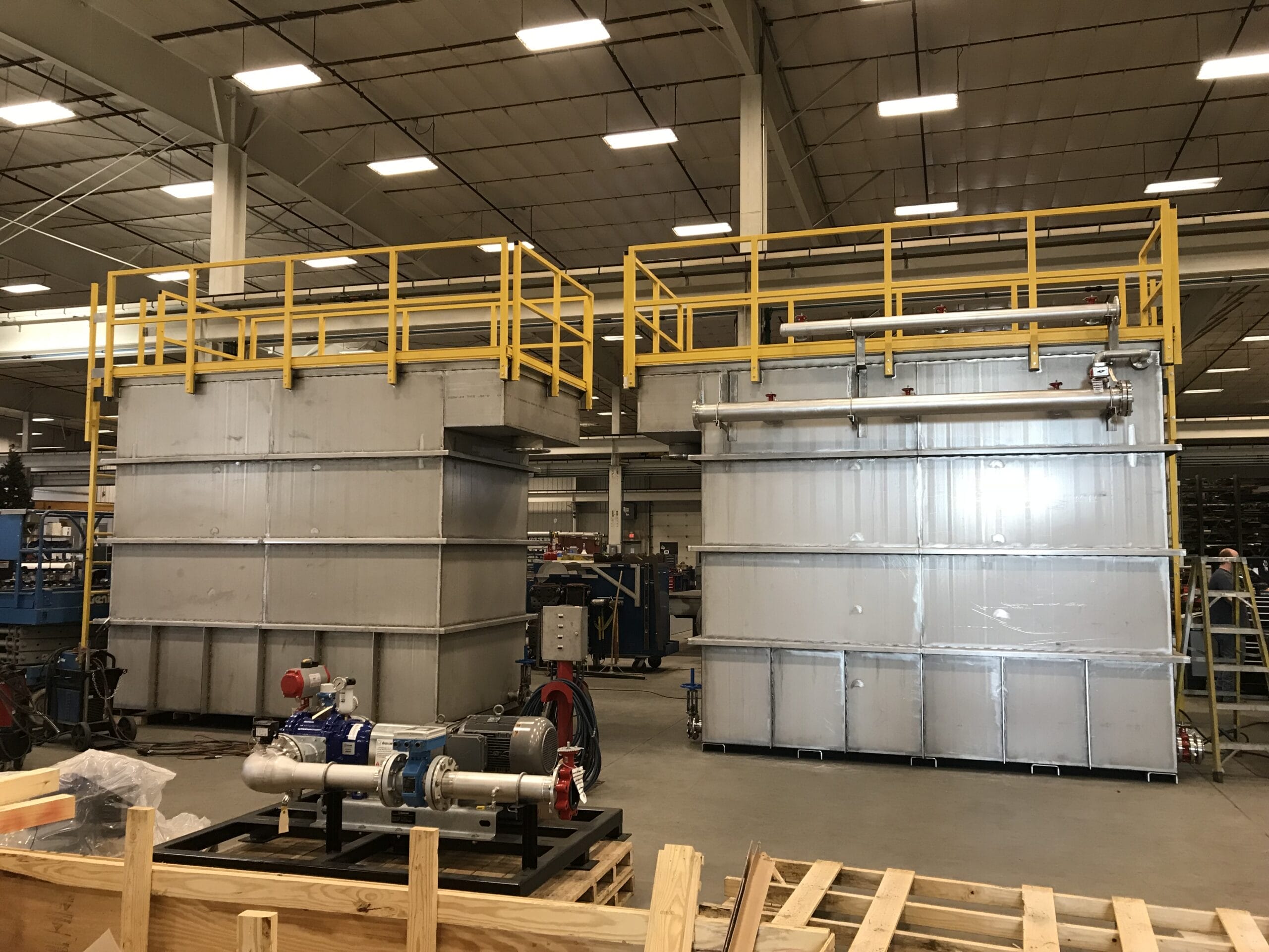 Water filtration system with fiberglass handrailing and expanded grating platform integration.