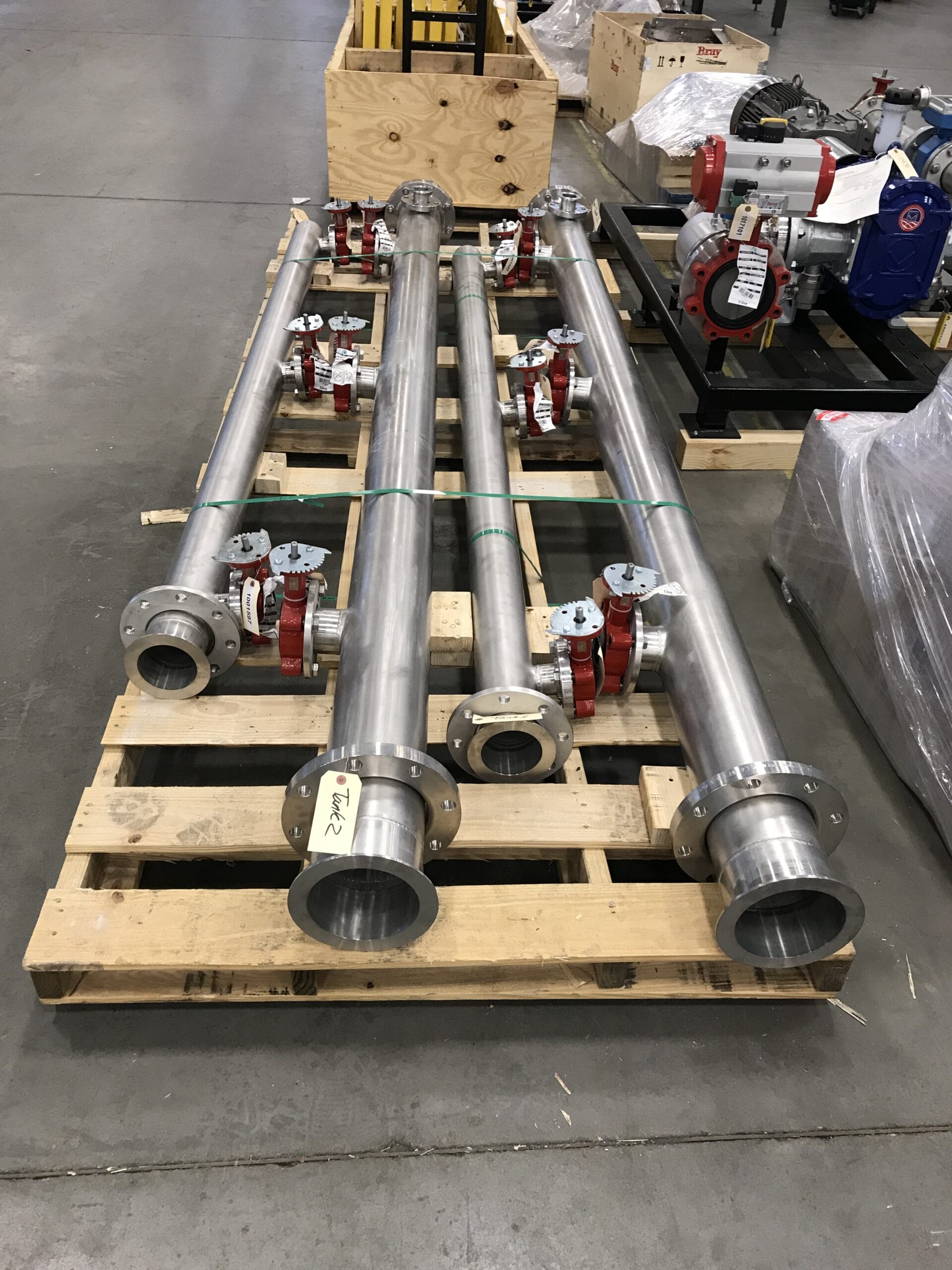 Stainless pipe spools with pre-assembled valves for water filtration systems.