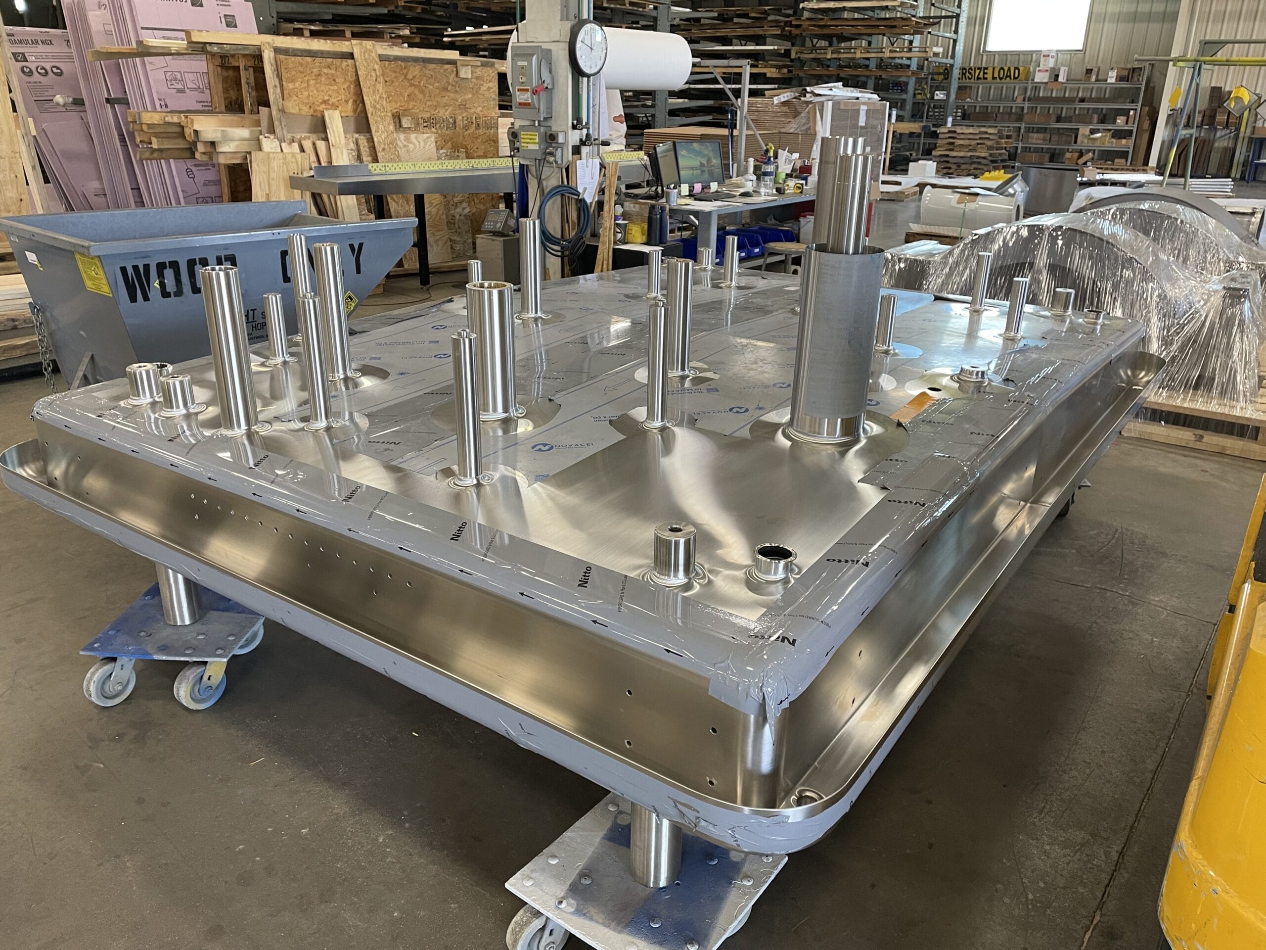 Weighing/filling shroud with TIG welds ground smooth; #6 stainless finish.