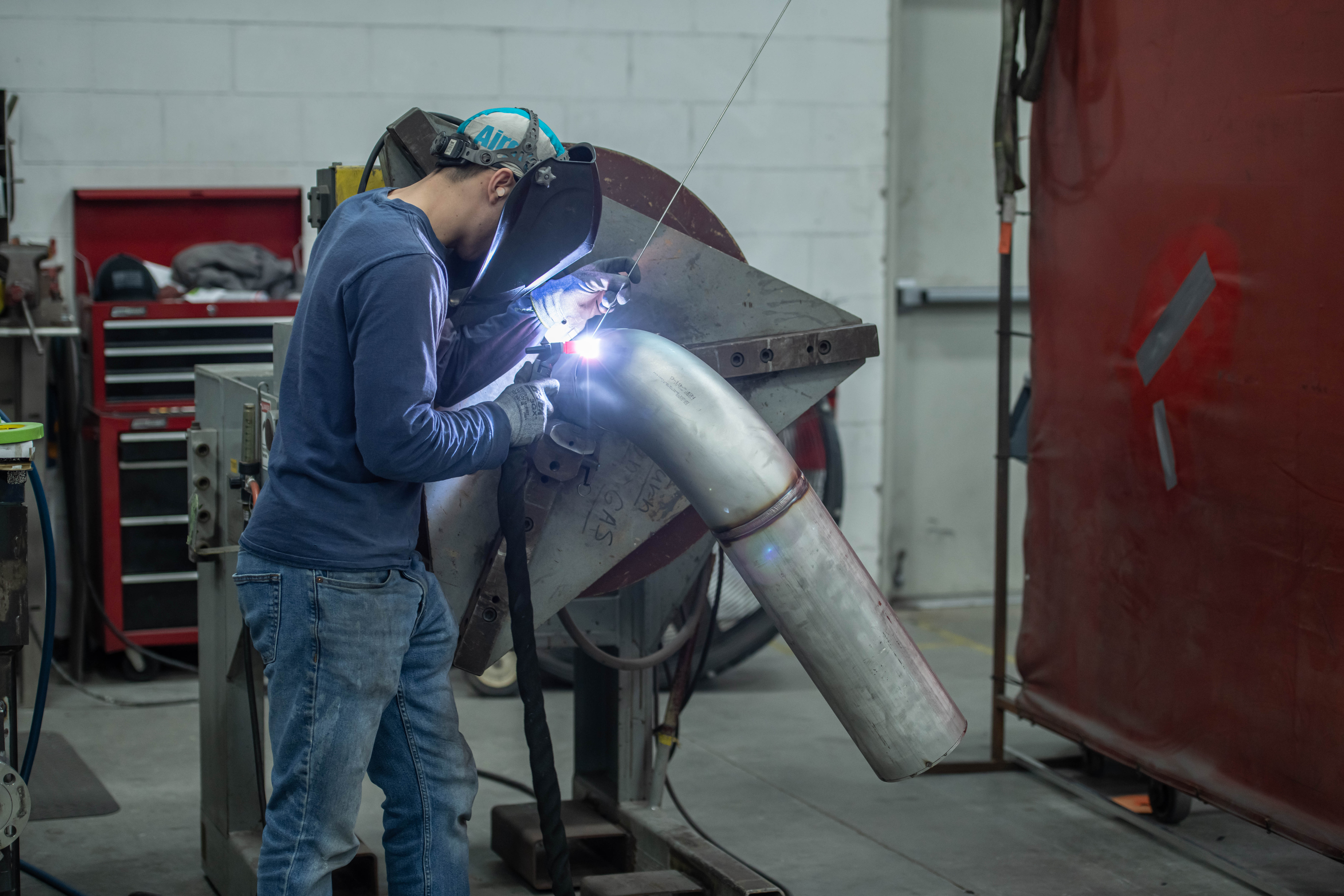 TIG welding of formed stainless pipe section with precision fit-up.