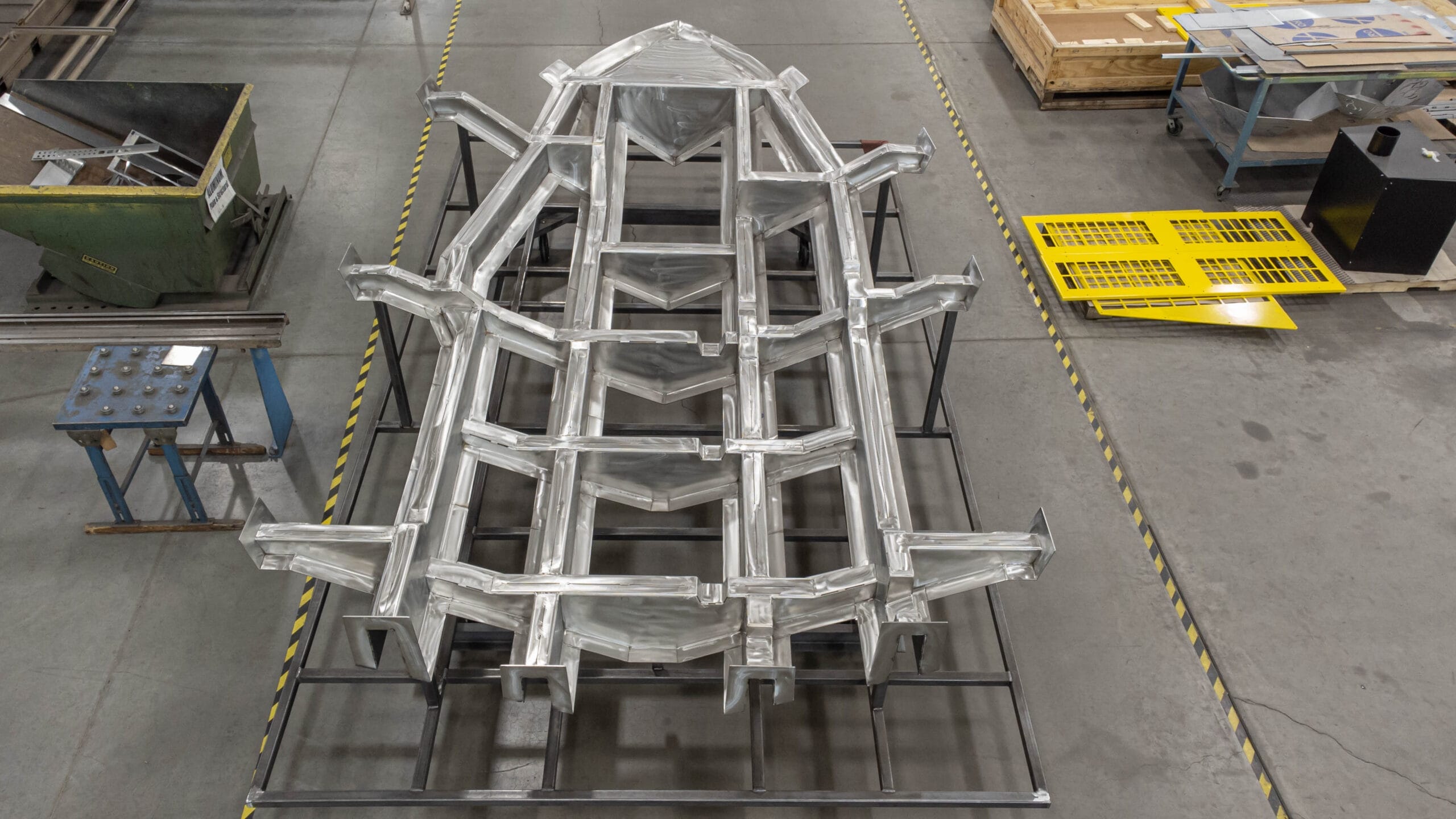 Large stainless structural assembly with blended welds and uniform surface finishing.